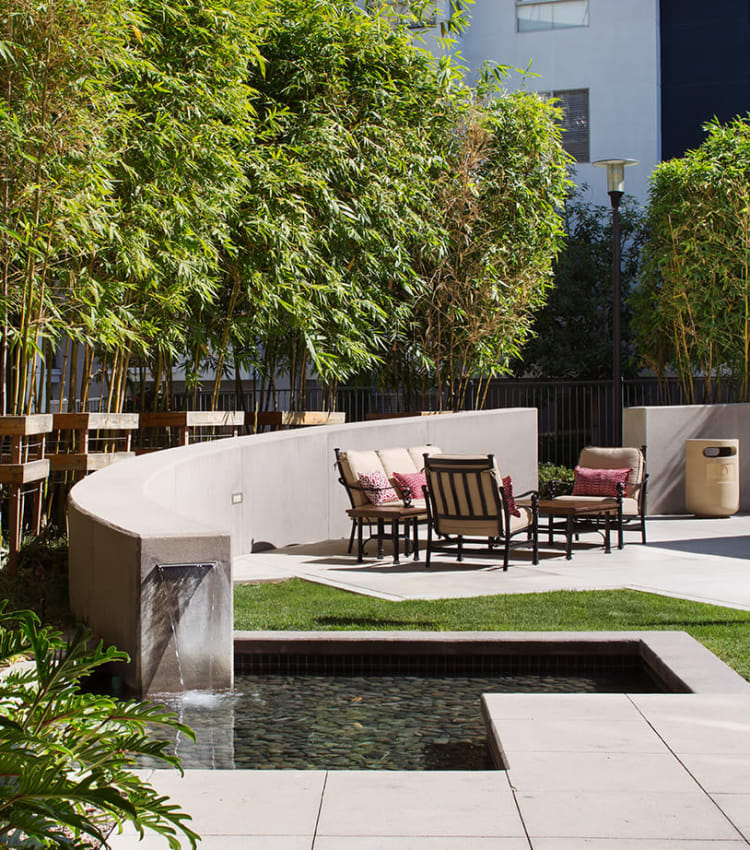 Relaxing outdoor common area with a water feature at Sofi Warner Center in Woodland Hills, California
