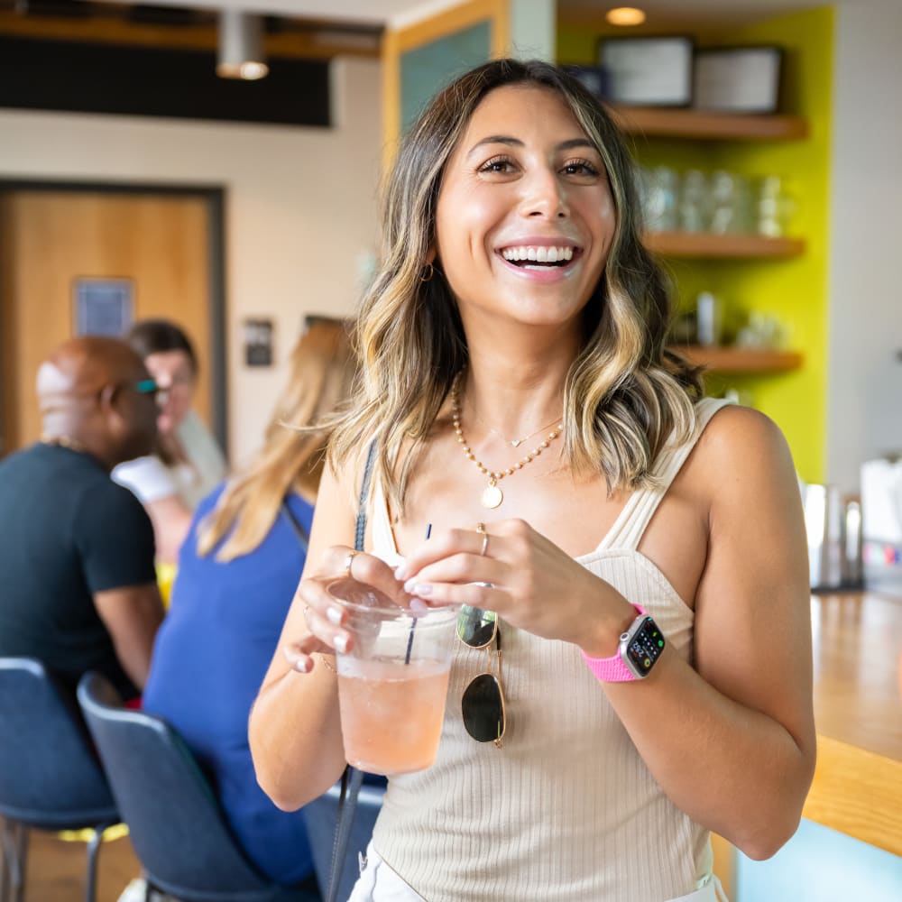 Resident smiling and holding an ice drink