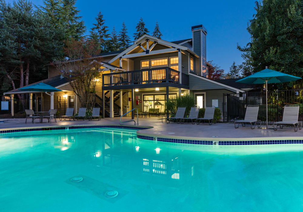 Pool with lounge chairs at Madison Sammamish Apartments in Sammamish, Washington