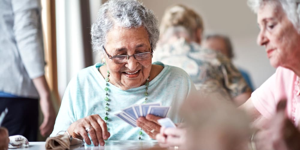 Residents playing cards at a Ridgeline Management Company senior living property