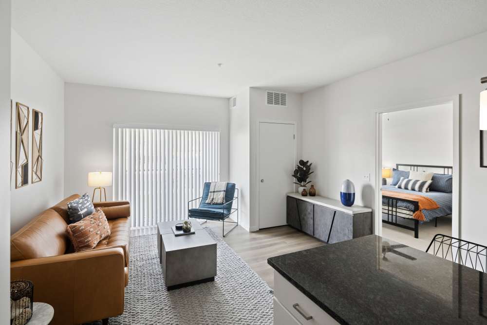 Living room with a comfortable couch at Axle Apartments in Fridley, Minnesota
