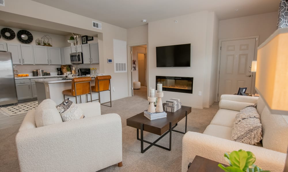 Model living room with open floor plan at Bend at New Road Apartments in Waco, Texas