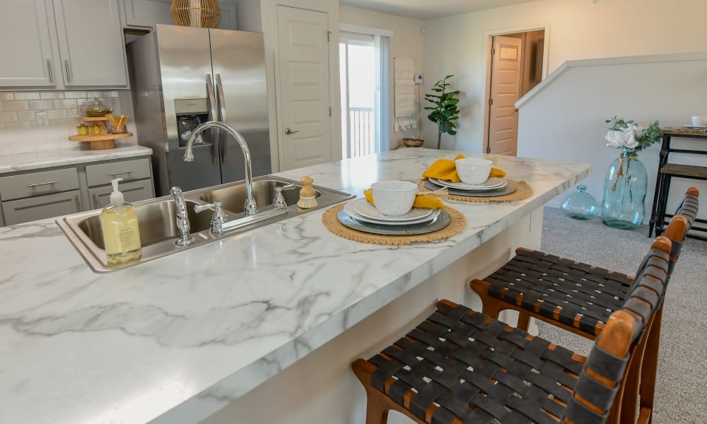 Spacious kitchen with granite countertops and light cabinetry at 97@ North Oak in Kansas City, Missouri