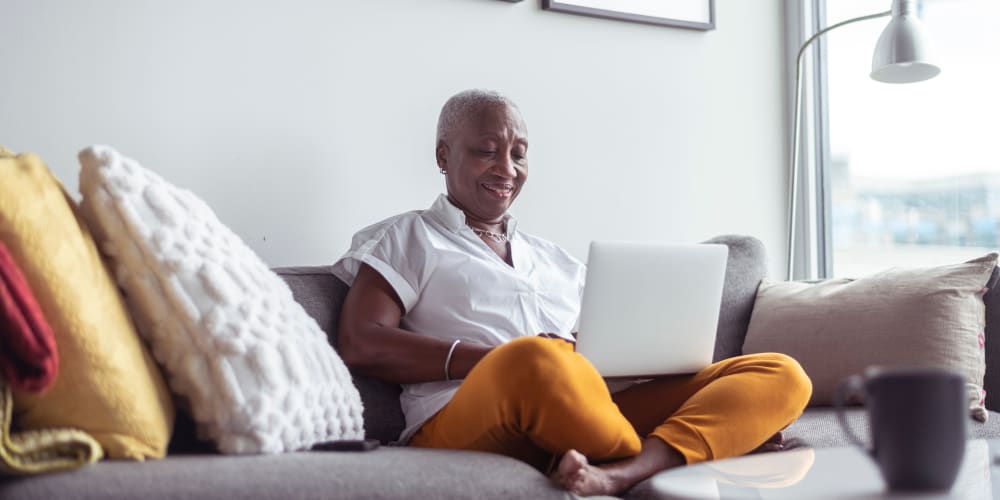 Resident on laptop at Legends 267 Apartments in Kansas City, Kansas