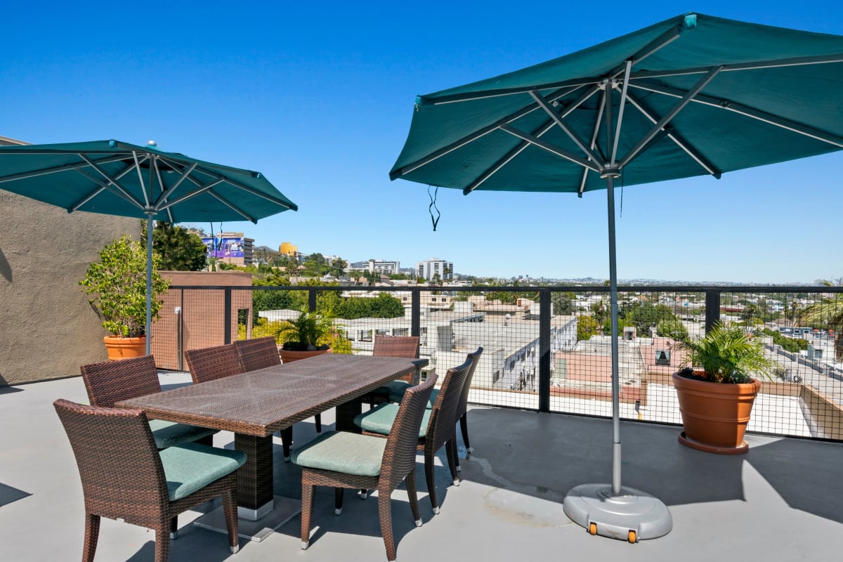 Umbrellas and table on rooftop patio at Ascent, West Hollywood, California