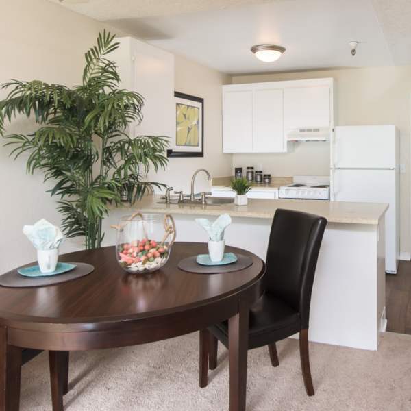 Apartment with carpeted dining area next to the kitchen at Martinez Hillside in Martinez, California