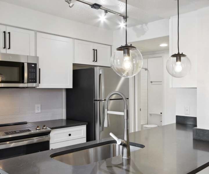 Kitchen with granite countertops and stainless-steel appliances at Stillwater in Charlotte, North Carolina