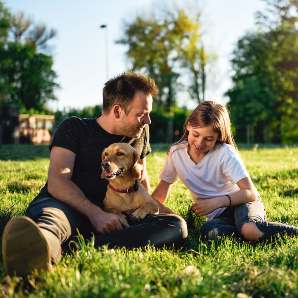 Man with his dog and daughter outside at The Metro at Clearview in Metairie, Louisiana