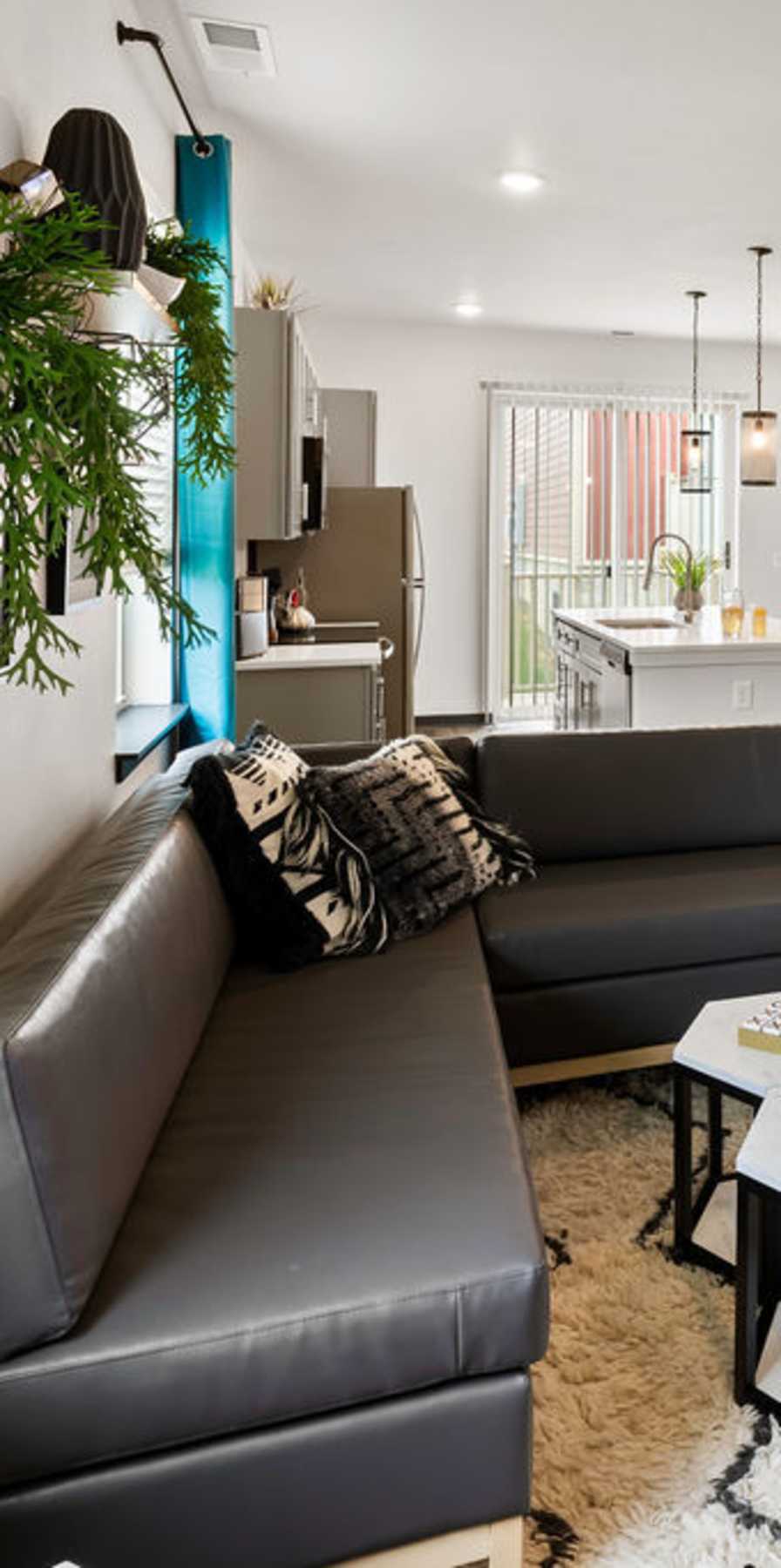 Living room with a couch and pillows at Atlas on 17th in Bloomington, Indiana