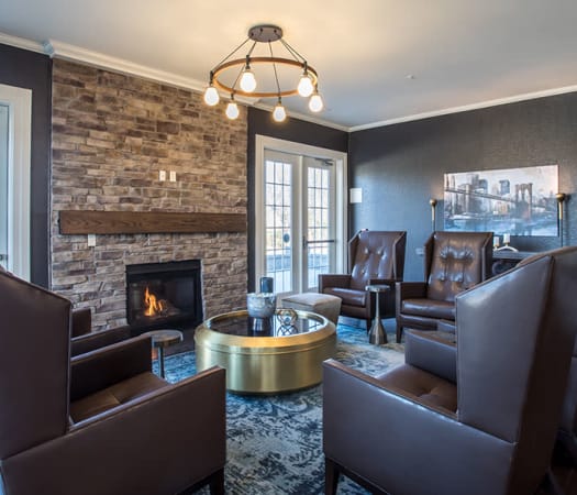 Clubhouse lounge with fireplace at Fairview at Town Center Apartment Homes in Rochester, New York