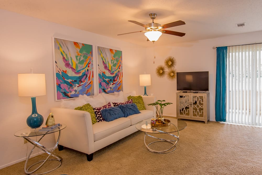 Model living room featuring sliding glass doors at Windsail Apartments in Tulsa, Oklahoma