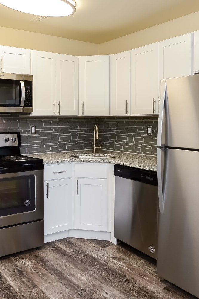 Kitchen with stainless steel appliances and whitecabinets at Lumberton Apartment Homes in Lumberton, New Jersey