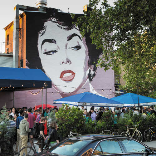 Lively outdoor event with colorful umbrellas and large crowd at Jefferson Marketplace in Washington D.C., District of Columbia