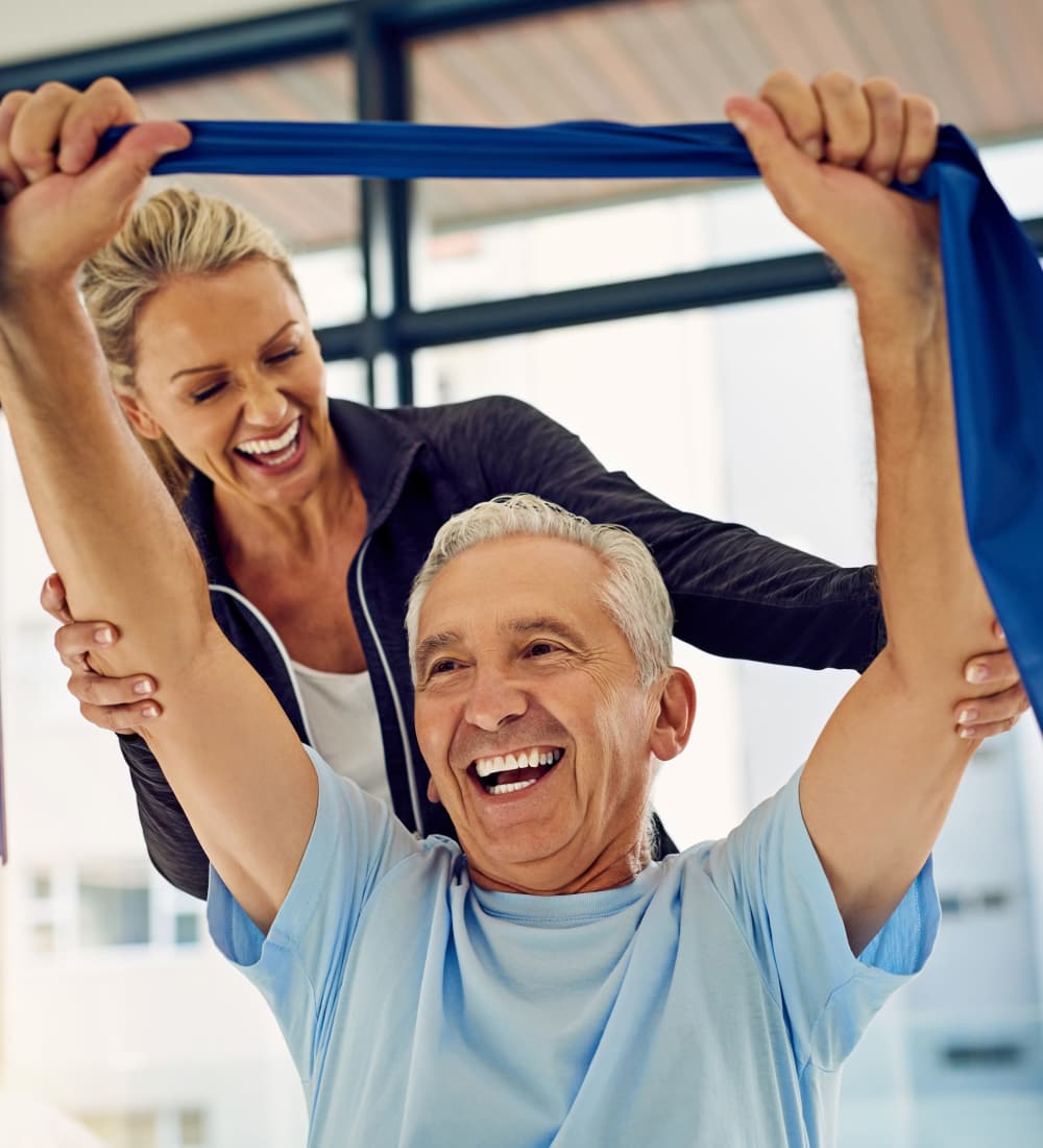 Staff member working with senior rehab resident at Heritage Health Care in Chanute, Kansas