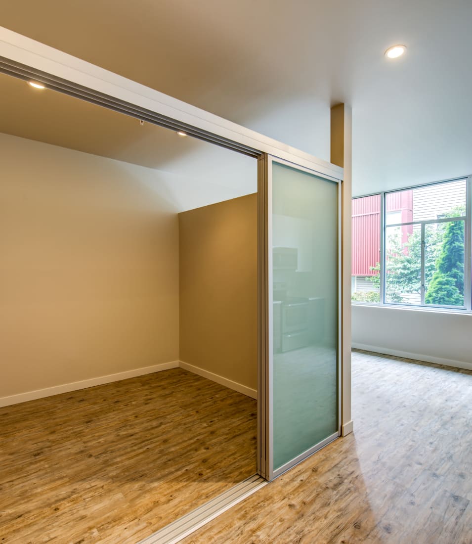 Open-concept layout with hardwood flooring and an office area in a model home at Verse Seattle in Seattle, Washington