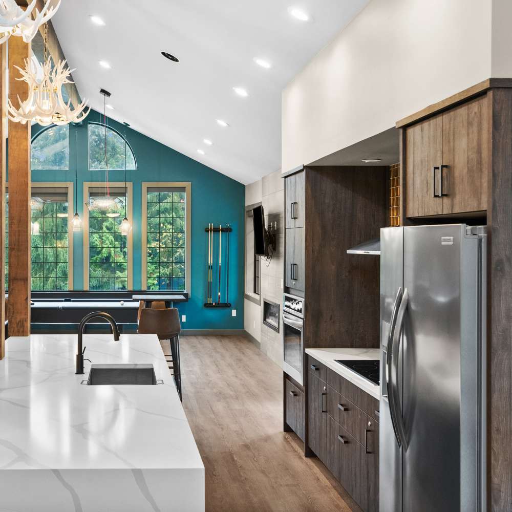 Clubhouse kitchen with refrigerator at Lodge at Madrona Ridge in Tacoma, Washington