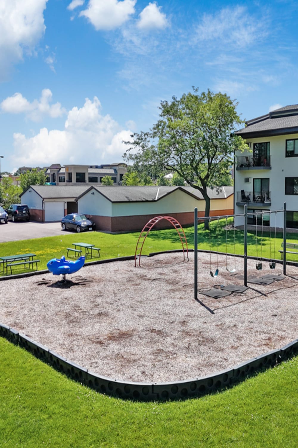 Playground with surrounded by green lanscape at Equinox Apartments in Saint Anthony, Minnesota