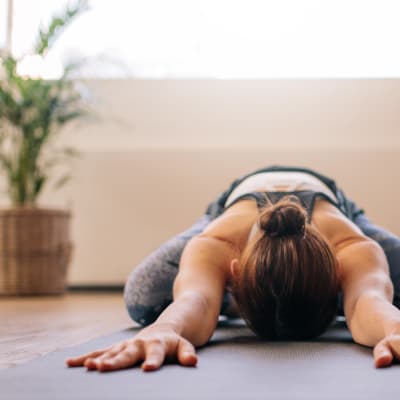 Resident stretching in the fitness center at Sofi at Forest Heights in Portland, Oregon