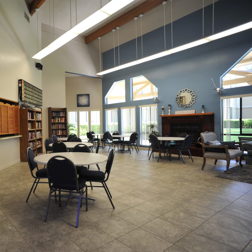 Community room with a fireplace, library, and vaulted ceilings at Glendora Gardens in Glendora, California