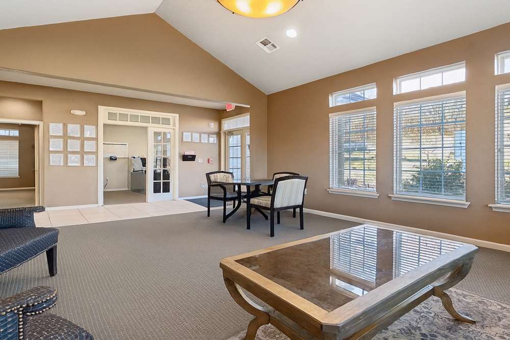 Inviting common area with abundant natural light and stylish seating at Covington Woods Apartments in Lansing, Kansas.