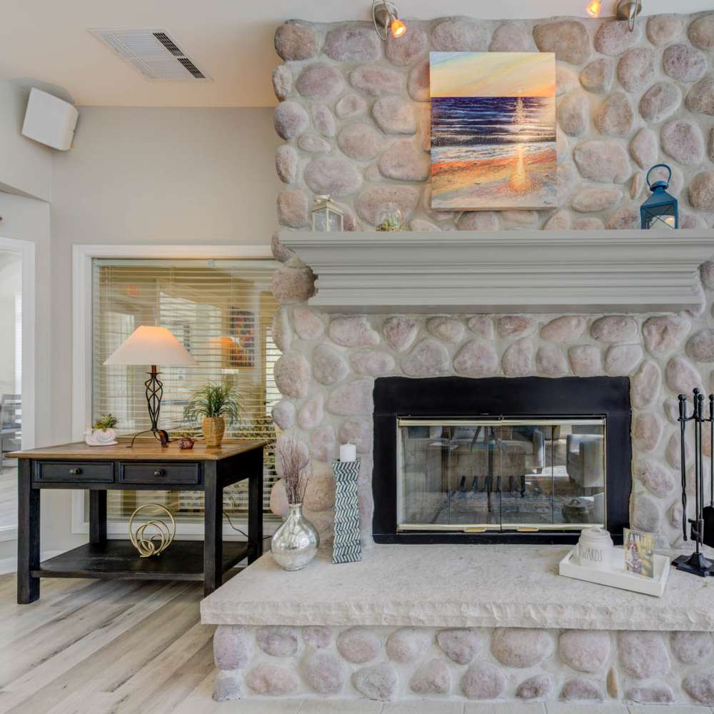 Inviting living space with a charming stone fireplace and modern decor at Boulder Springs in Maryland Heights, Missouri.
