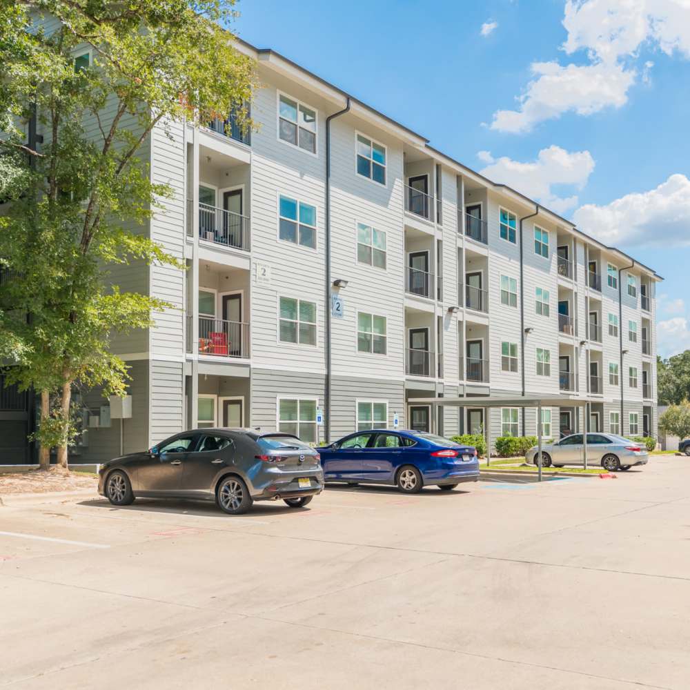 Car parking view of the building at Regency Gardens in Bryan, Texas