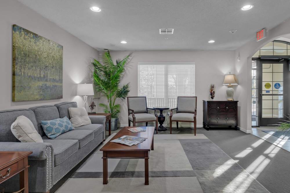 Common seating area with large couch, chairs and coffee table at River Ridge in Sand Springs, Oklahoma