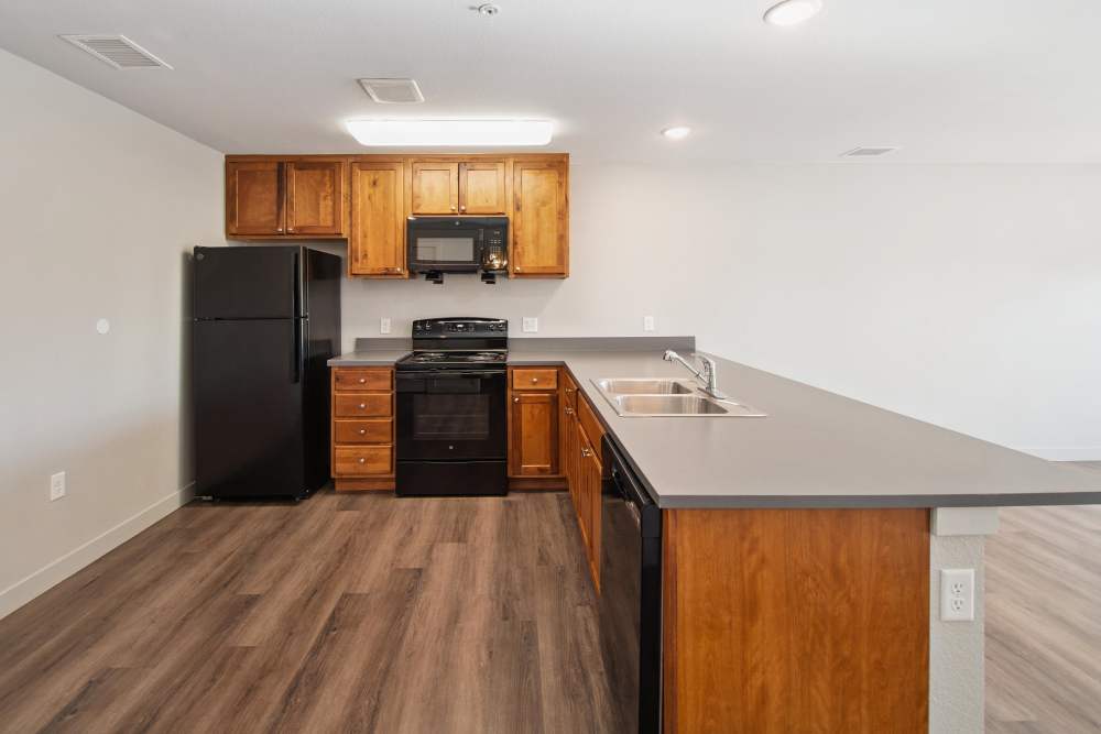 Kitchen with black appliances at Villas At Mesa Ridge in Fountain,Colorado