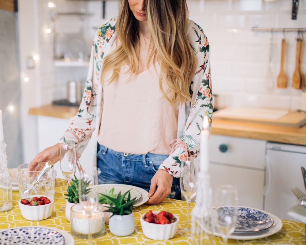 Resident setting the table for a special meal in her new home at Terra Martinez in Martinez, California