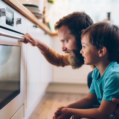 Father and son watching the oven at The Kensington in Pleasanton, California