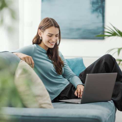 Resident attending video call in living room at Walnut Springs in Seguin, Texas