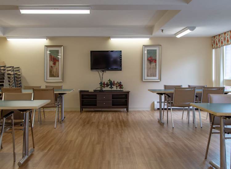 Wooden floor with tables and chairs at Victory Gardens in East Boston, Massachusetts