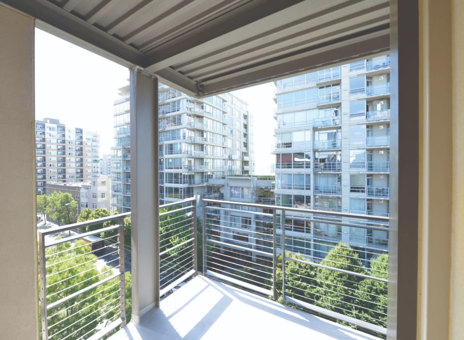 Private balcony with a terrific view of the neighborhood outside a model home at 2900 on First Apartments in Seattle, Washington