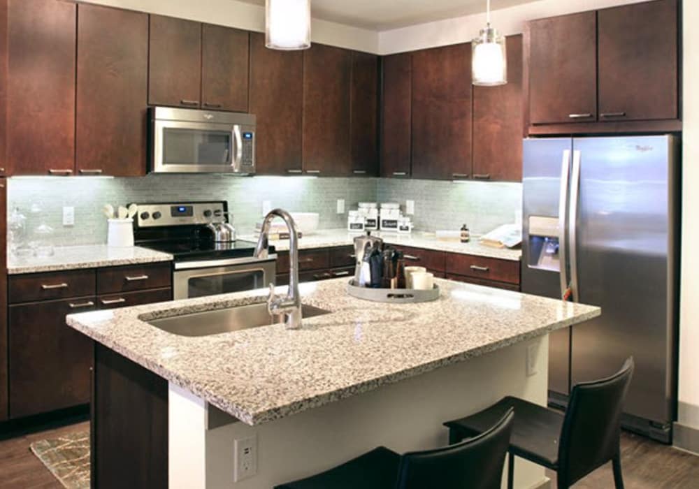 Kitchen with stainless steel appliances at Axis at The Rim in San Antonio, Texas
