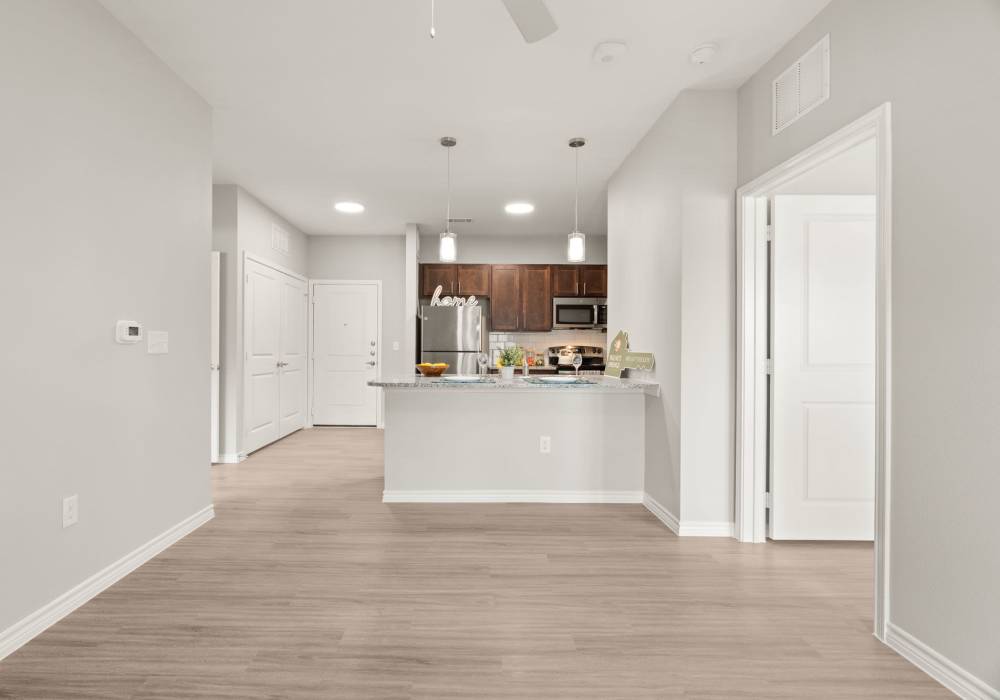 Open living room with kitchen at Walnut Springs in Seguin, Texas