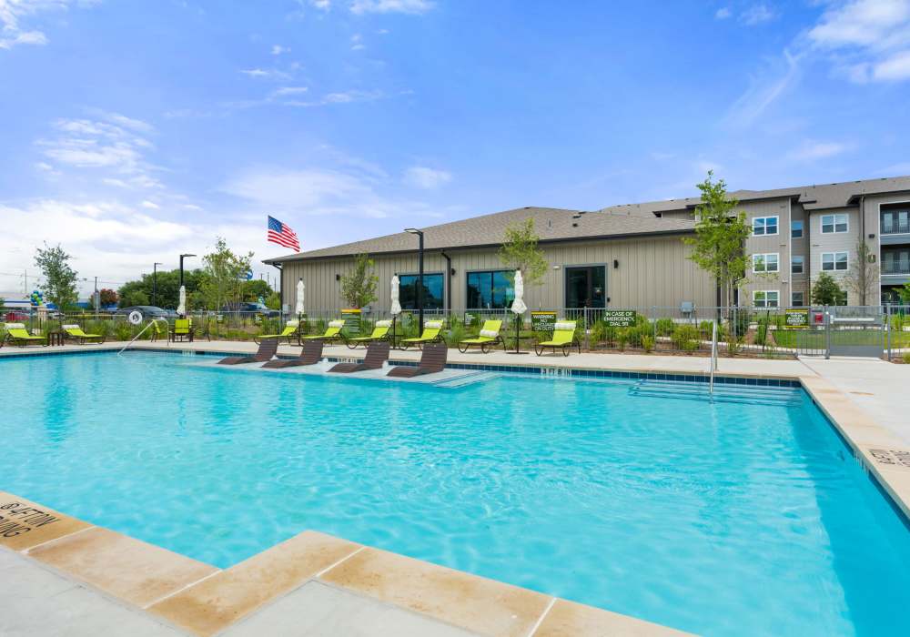 Outdoor pool with lounge chairs at Walnut Springs in Seguin, Texas