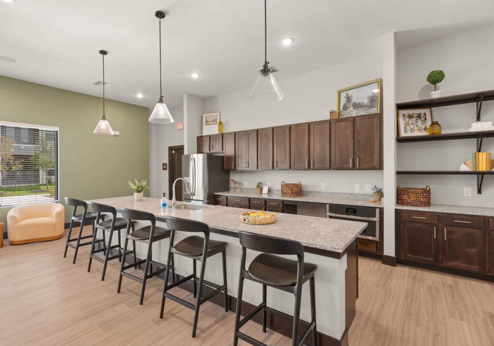 Clubhouse kitchen with seating island at Walnut Springs in Seguin, Texas