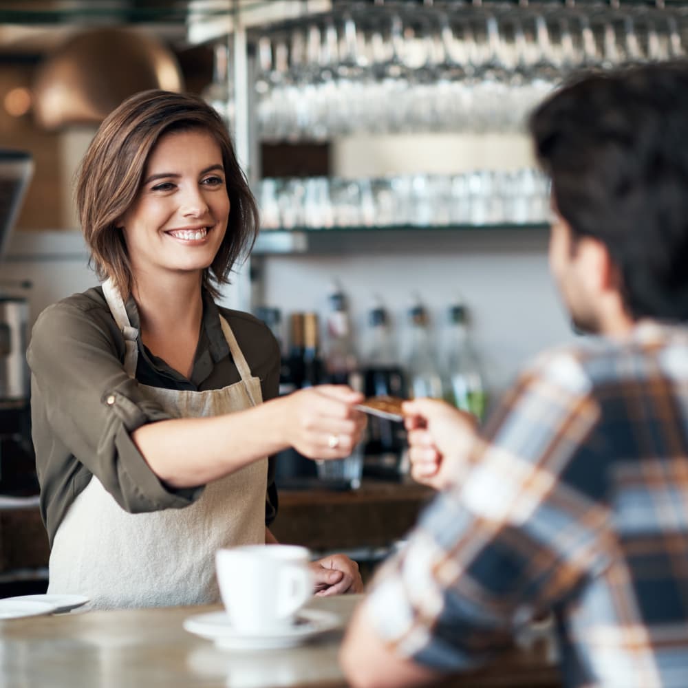 A welcoming barista helping a customer in Camden, New Jersey