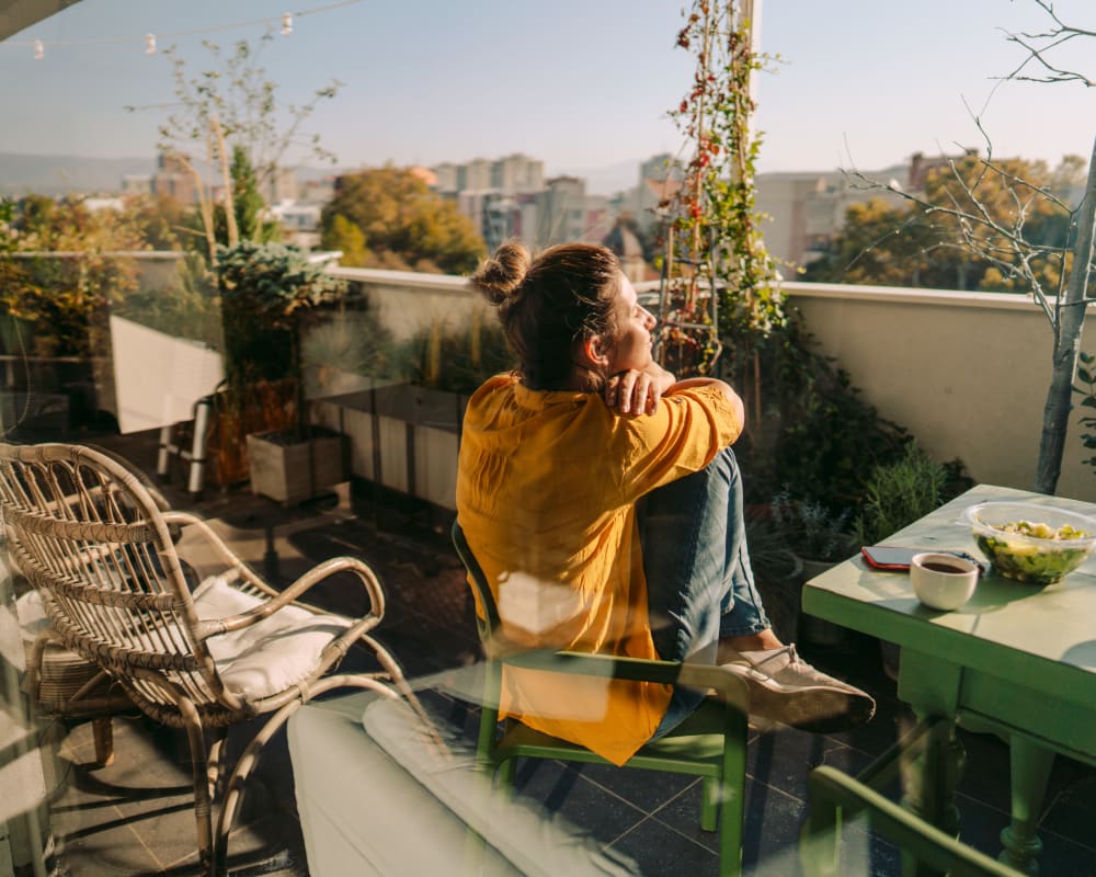 Resident relaxing on their patio at The Knoll Redmond in Redmond, Washington