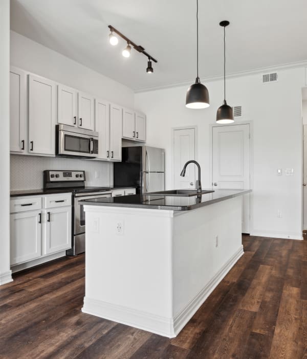 Model kitchen with island at West Lake Vistas in Austin, Texas