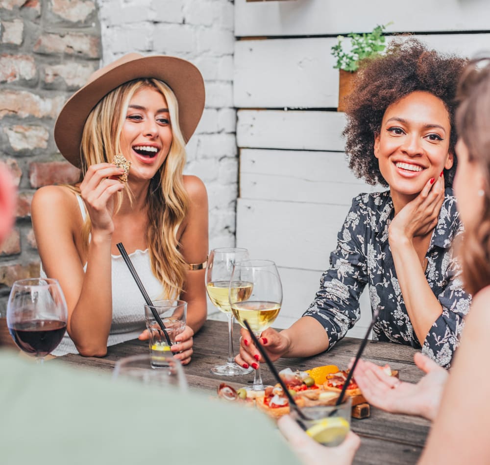 Resident friends enjoying drinks and appetizers at their favorite spot near Sofi Canyon Hills in San Diego, California