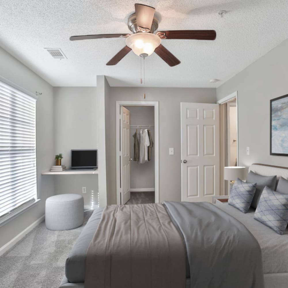 Comfortable bedroom with walk-in closets and a window at Crestmont in Columbia, South Carolina.