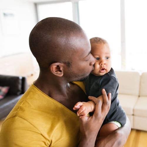 A father holding his child at Shelton Circle in Virginia Beach, Virginia