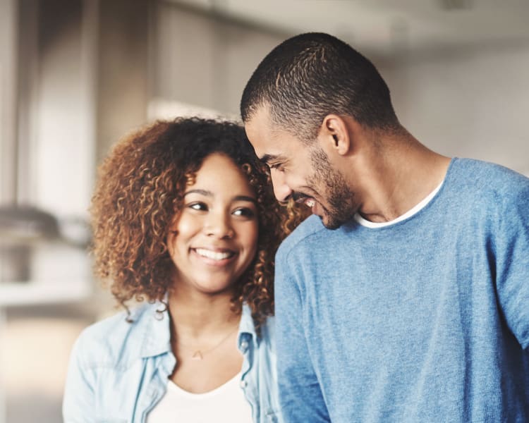 Resident couple smiling at each other in their new home at Sofi Redwood Park in Redwood City, California
