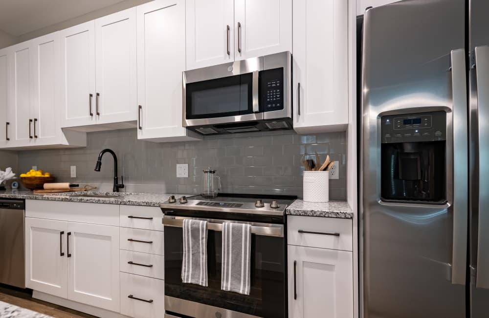 Cozy kitchen with latest energy-efficient appliances including refrigerator and microwave at North Bay Landing in Panama City, Florida