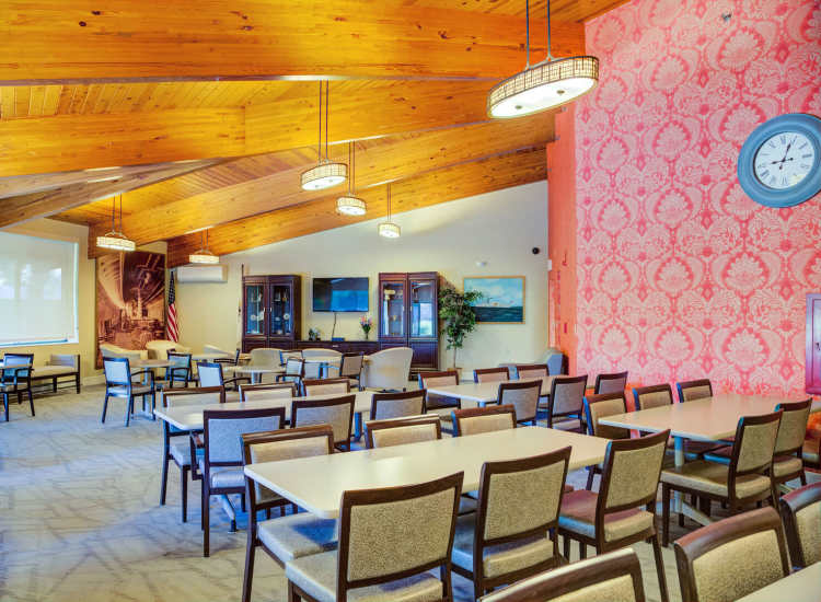 Community gathering space with chairs and tables at Borden Place Apartments in Fall River, Massachusetts