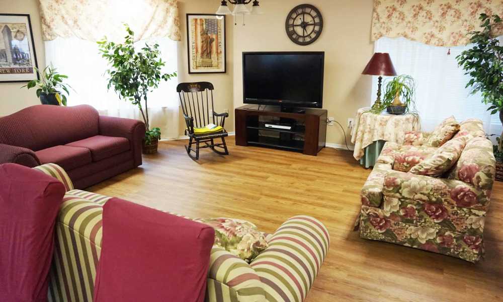 Cozy living room with vibrant furniture and natural light at The Parc at Bakers Pointe in Richland Hills, Texas