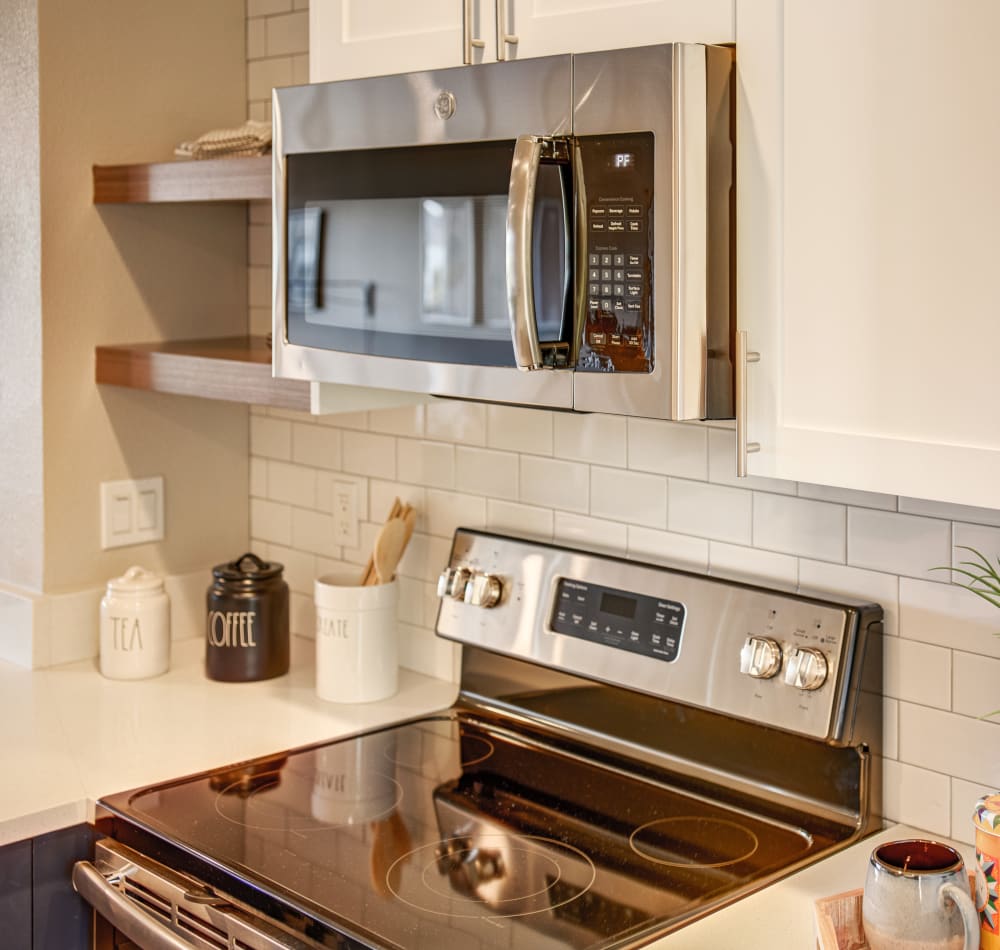 Subway tile backsplash and stainless-steel appliances in a model home's kitchen at Harbor Point Apartments in Mill Valley, California