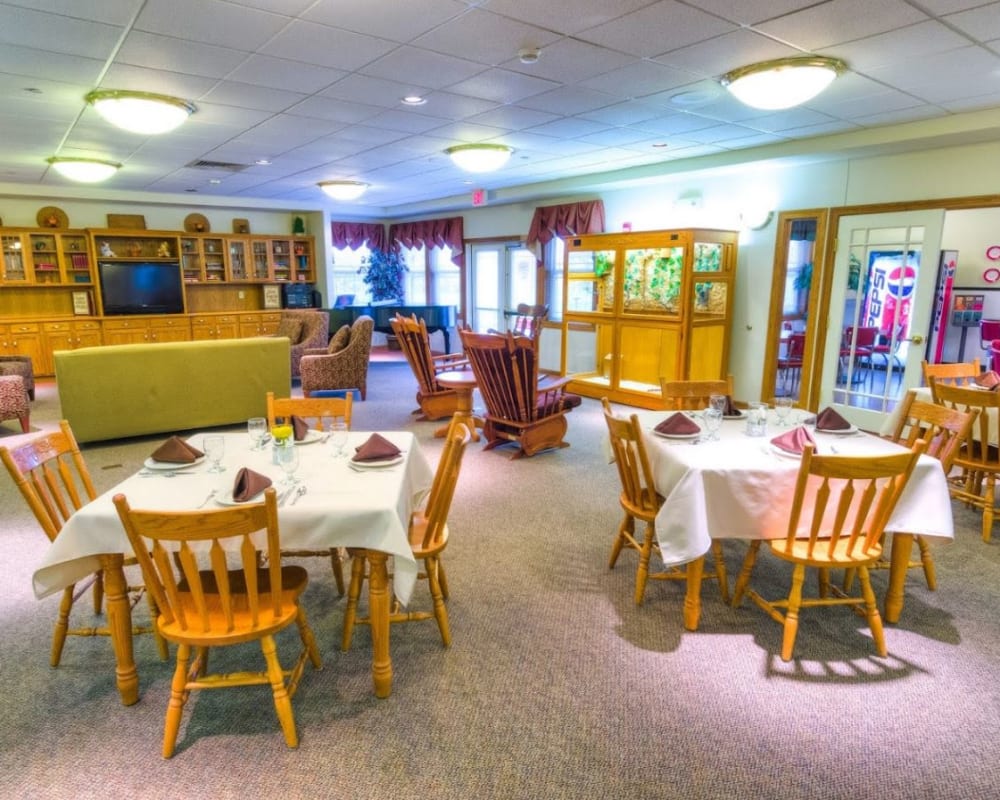 Common area with dining tables and sofa style seating at Addington Place of Fairfield in Fairfield, Iowa