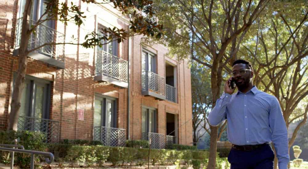 Resident walking beside the apartment at St. James in Dallas, Texas